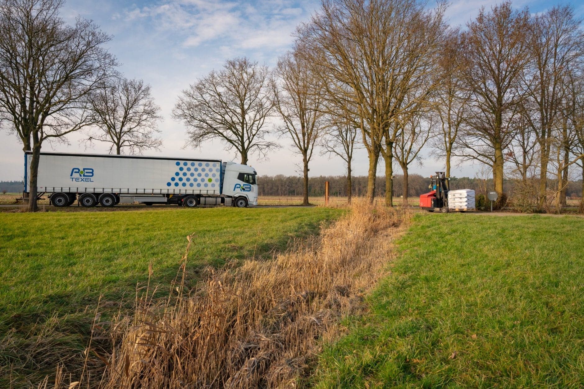 Vrachtwagen rijdt naast erf