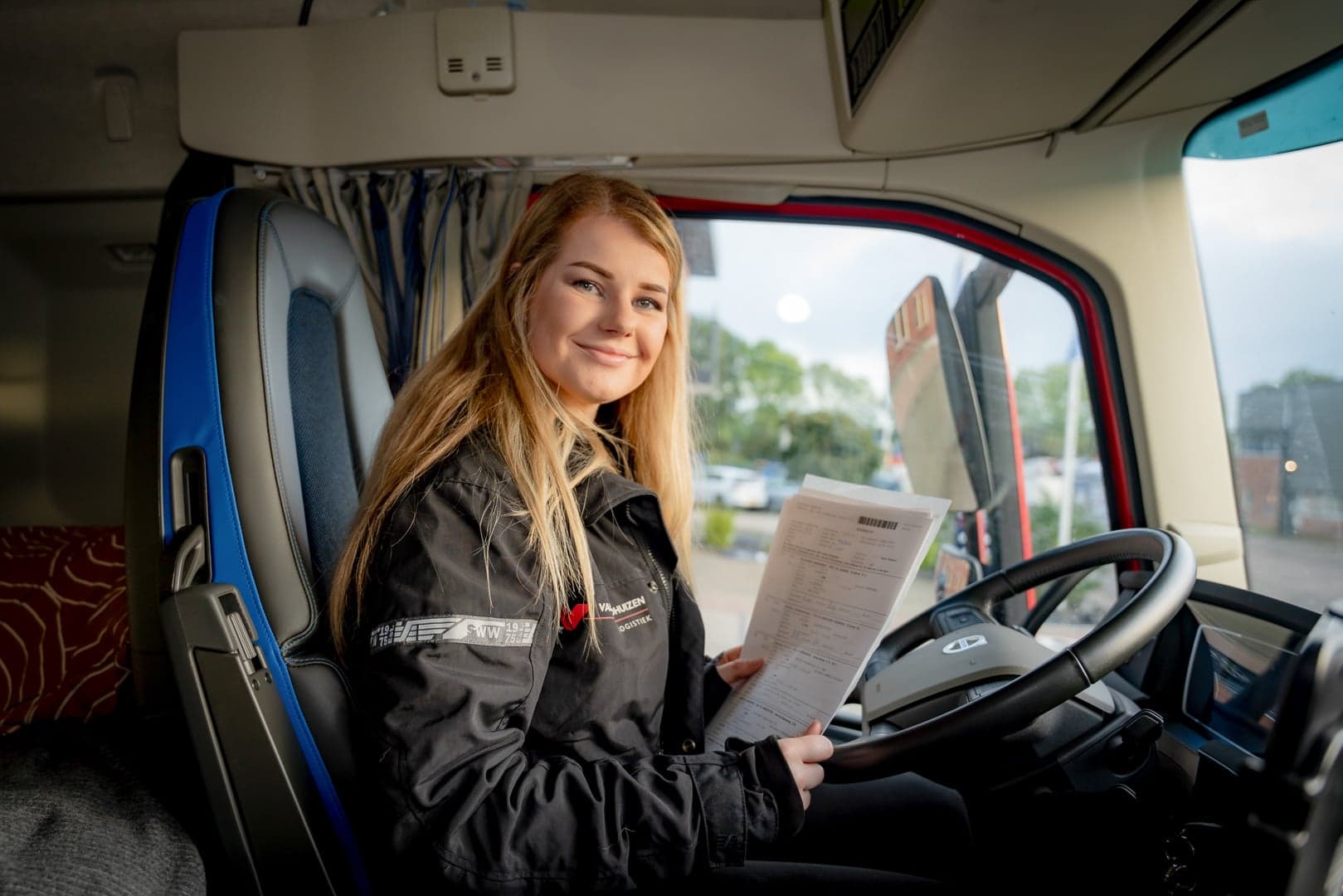 vrachtwagenchauffeur Sanne Ansmink met papieren in cabine vrachtwagen