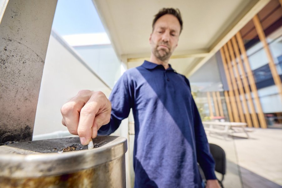 Werknemer transport en logistiek drukt sigaret uit