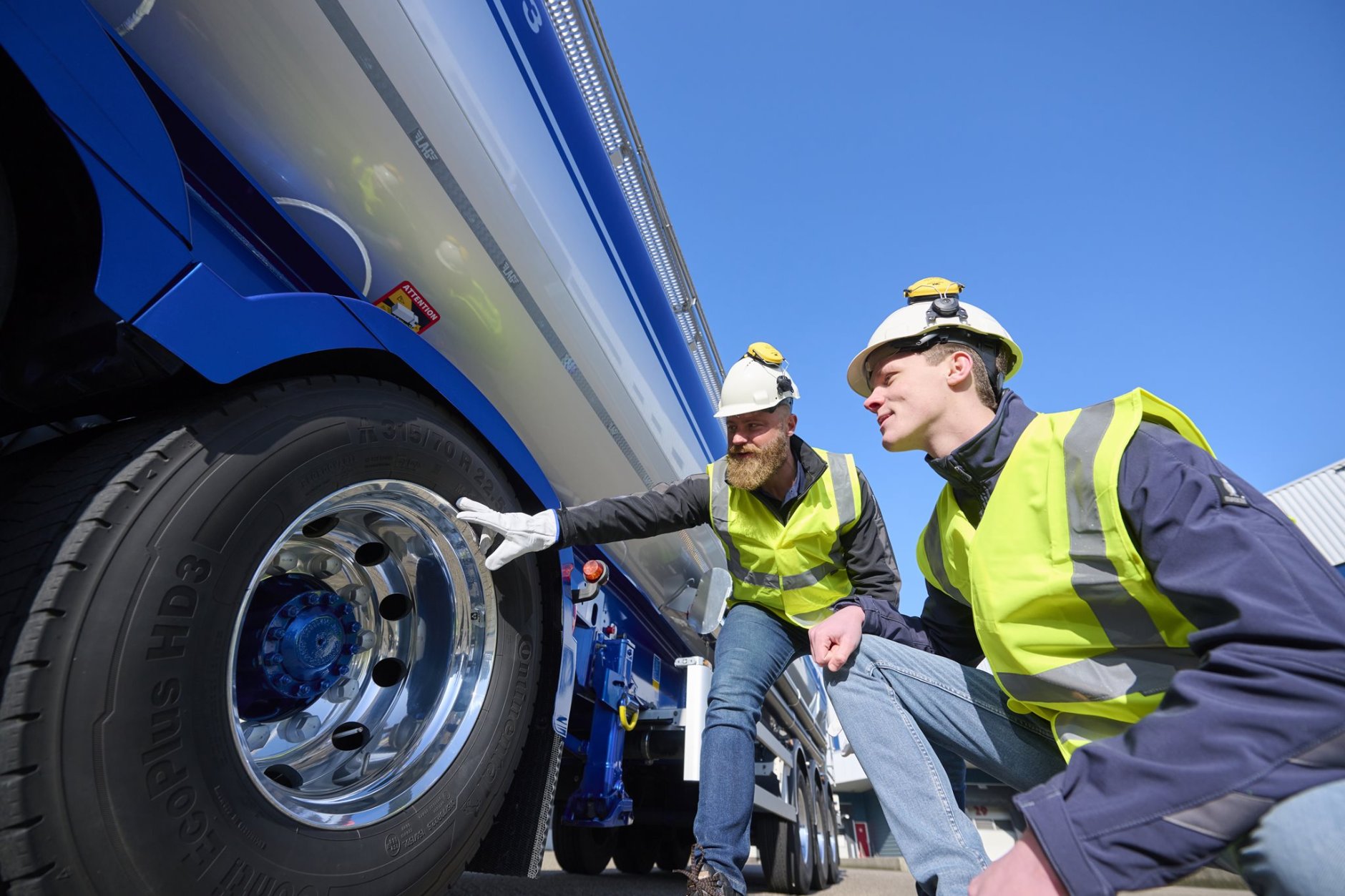 Opleider met leerling (werknemer) bij vrachtauto
